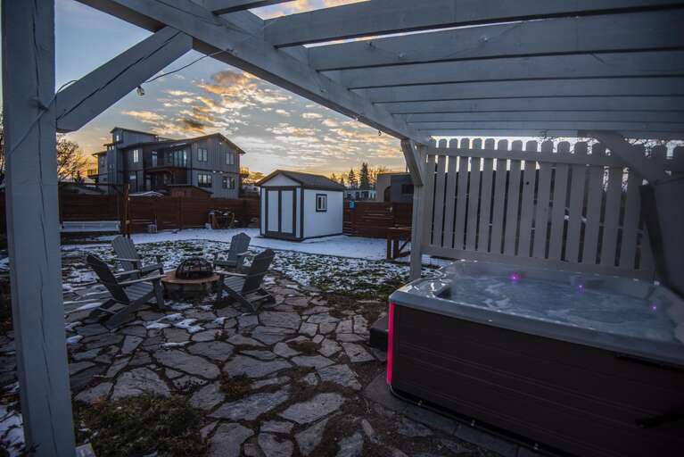 Step outside into the large private backyard area which features a brand new 6-person hot tub under a pergola wrapped in mood-setting string lights along with a gas grill and firepit seating area.