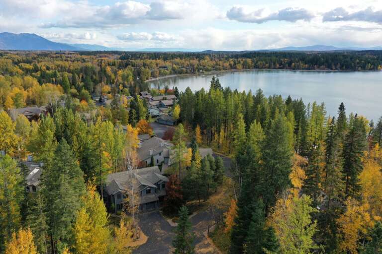 Aerial view of property showcasing close proximity to private beach on Whitefish Lake.