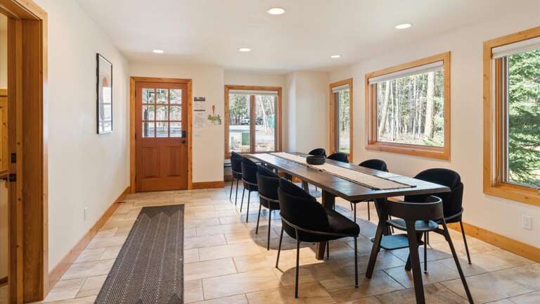 Open concept dining area with seating for 8 plus two Stokke high chairs.