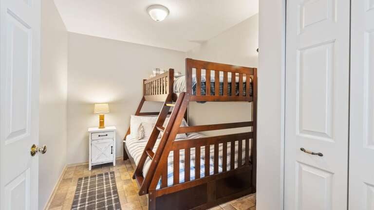 Bunk room with full sized bed and twin bed on top. Also, has a closet.