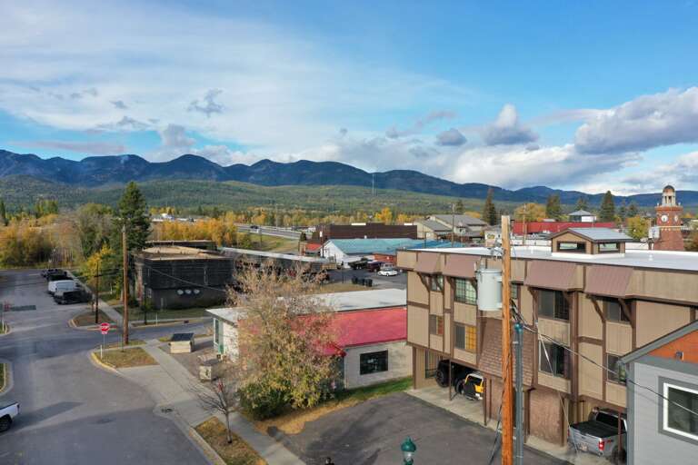 Aerial view of the building in the heart of downtown Whitefish with view of Big Mountain