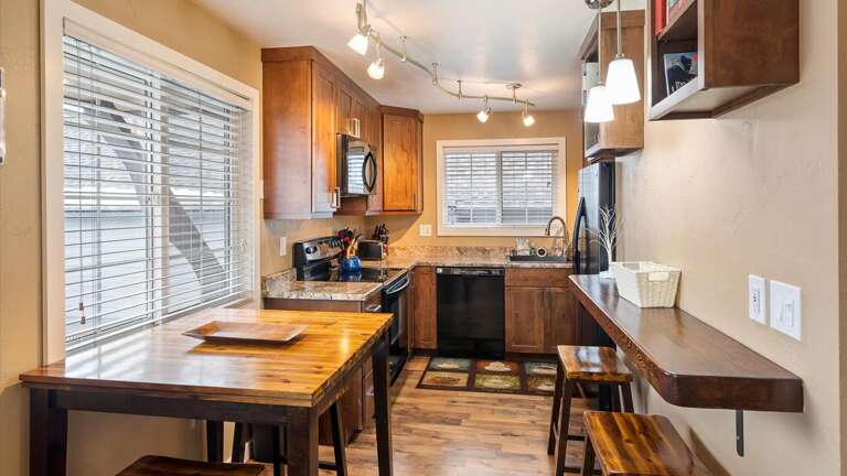 Dining space and fully stocked kitchen with working space for all our work from home travelers.