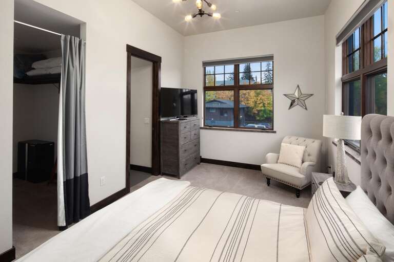 The grand master bedroom features alpine views from the luxury king bed, walk-in closet, ensuite master bathroom, seating area,