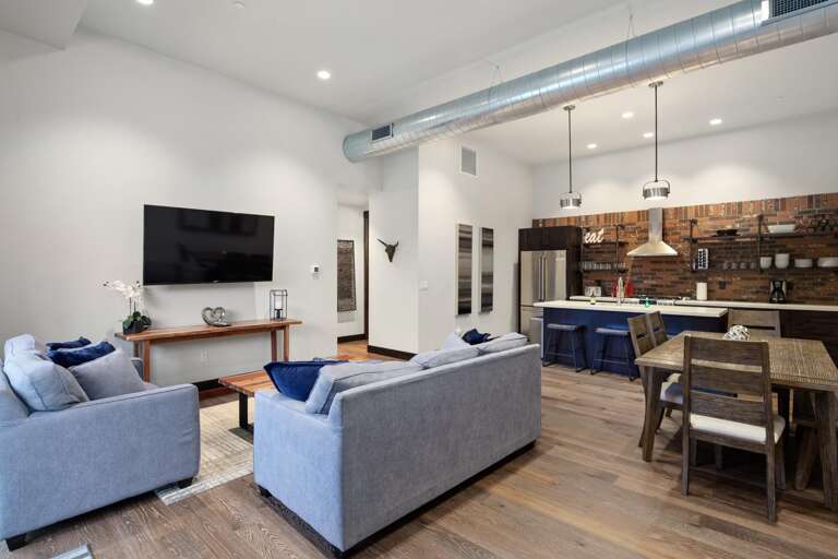 The grand room features an open concpet living, dining, and kitchen area.