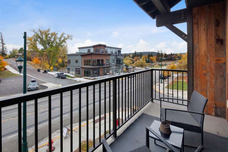 The large balcony features an outdoor seating area with views of downtown