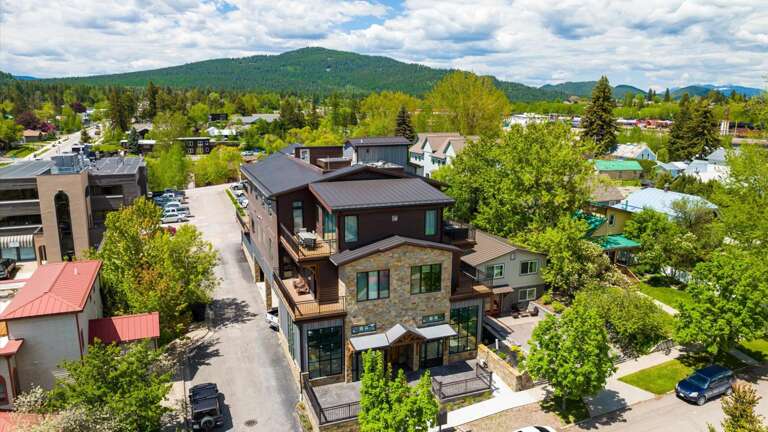 Front aerial view of the building located in the heart of downtown Whitefish.