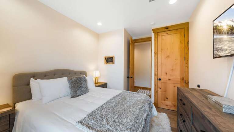 Junior master bedroom includes a luxury queen mattress and linens, HDTV with streaming capabilities, closet