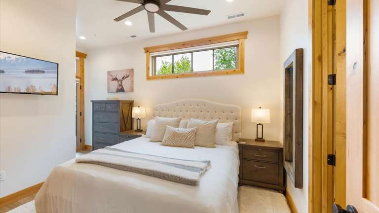 Master suite includes luxury king mattress and linens, large closet, HDTV with streaming capabilities, ensuite bathroom, access to deck with mountain views.
