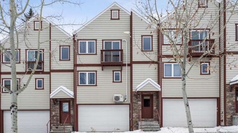 The front entrance of the property (also includes access to the 1 car garage which fits up to mid-size SUVS). If you hae a larger vehicle there is additional parking on either side of the building.