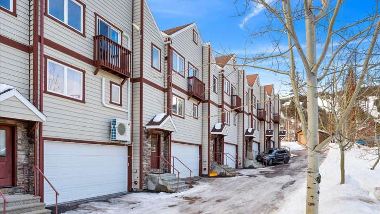The front entrance of the property (also includes access to the 1 car garage which fits up to mid-size SUVS). If you hae a larger vehicle there is additional parking on either side of the building.