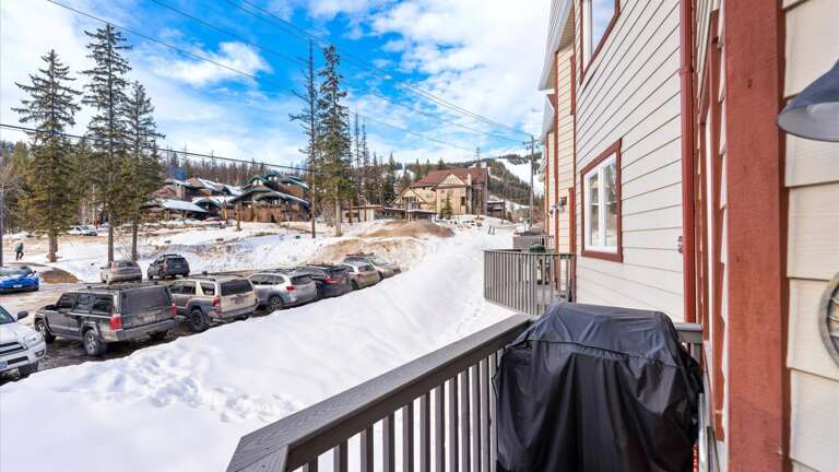 The main floor balcony off the living room features a gas grill (propane provided) and mountain views of the slopes!