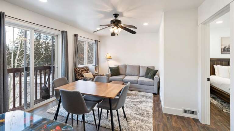 Off the master suite is a featured bonus room with a luxury queen-size sofa sleeper for additional sleeping options, a desk for our W.F.H. guests, HDTV with streaming capabilities, an arcade game, and a balcony with alpine views.