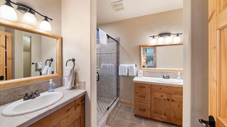 Ensuite master bathroom with double vanity, large walk-in shower, toilet.