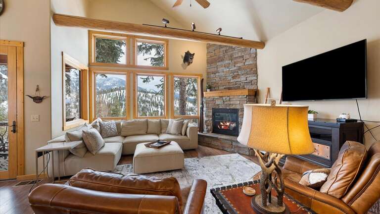 Luxurious open concept living room with gas fireplace, HDTV with streaming capabilities, and unparalleled alpine views of Whitefish Mountain Resort