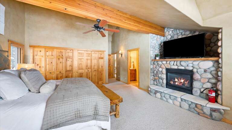 Master bedroom suite with luxury king bed, fireplace, HDTV with streaming capabilities, large closets, master bathroom suite with double vanity.