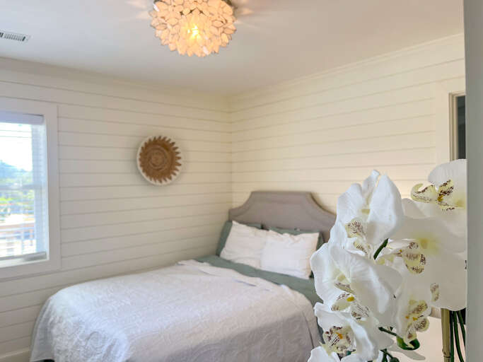 Tranquil bedroom with a queen-sized bed, great storage, and access to the modern bathroom. Tranquil bedroom with a queen-sized bed, great storage, and access to the modern bathroom.