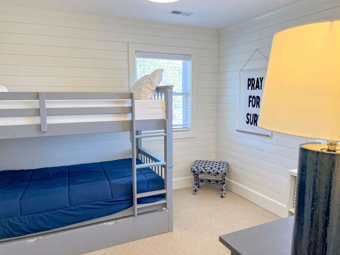 With room for everyone, enjoy this bunk room with Jack and Jill bath, a pool view and games for kids or adults of all ages.