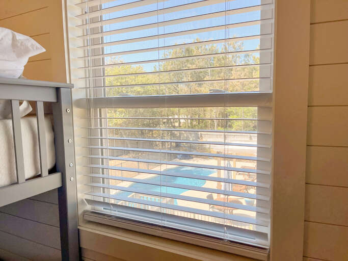 With room for everyone, enjoy this bunk room with Jack and Jill bath, a pool view and games for kids or adults of all ages. With room for everyone, enjoy this bunk room with Jack and Jill bath, a pool view and games for kids or adults of all ages.