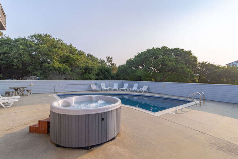 Outdoor Pool And Hot Tub With Deck Chairs