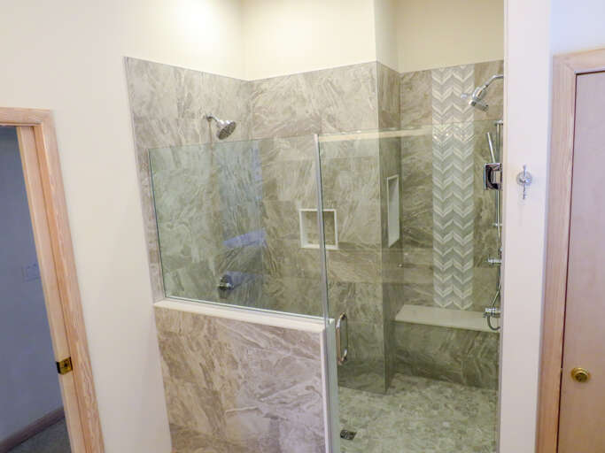 Enjoy the new luxury walk in shower with dual shower heads and bench.