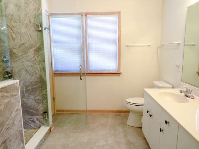 With a newly installed walk-in tile shower this master bath with double vanity is a vacation in of its own.