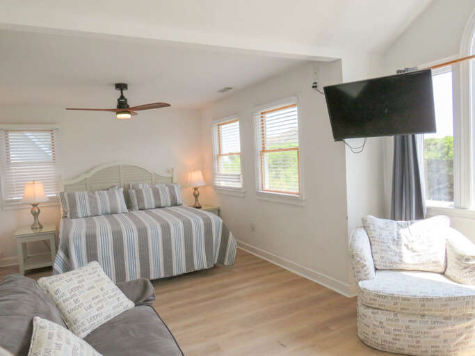 With its own bathroom this king master offers a comfy bed, smart TV and seating area.