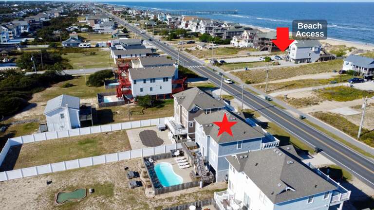 Aerial View Of A Seaside Residential Area With A Marked Vacation Rental And Beach Access