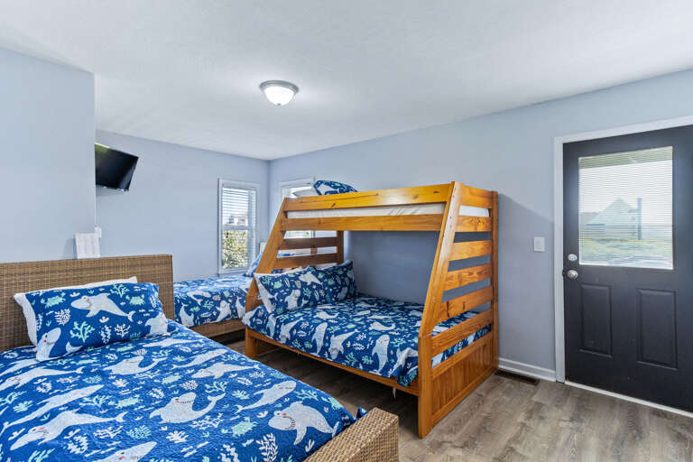 Located on the mid level just off the den, this bunk room has a full sized bed and 3 twins.