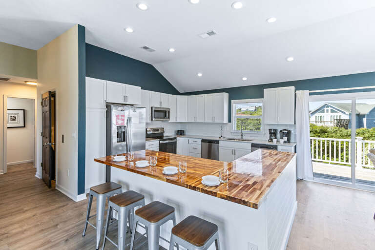 Well-appointed kitchen featuring granite countertops, upgraded appliances, and a breakfast bar, ideal for preparing home-cooked meals.
