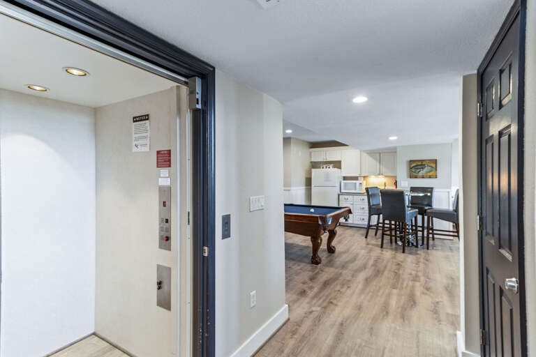 Half bath, kitchenette and laundry all surround this game room just off the pool and hot tub. Everything you&#39;ll need is here in this space to have a great time.
