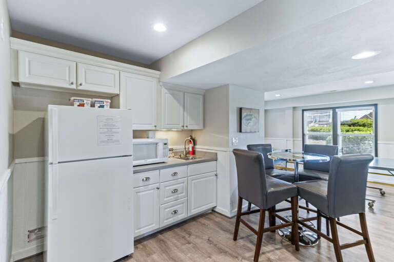 Half bath, kitchenette and laundry all surround this game room just off the pool and hot tub. Everything you'll need is here in this space to have a great time.