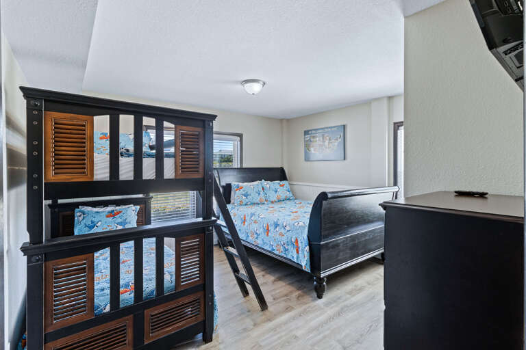 This ground floor bunk room has a full-sized bed and twin bunk large closet with a tall chest of drawers and Smart -TV.