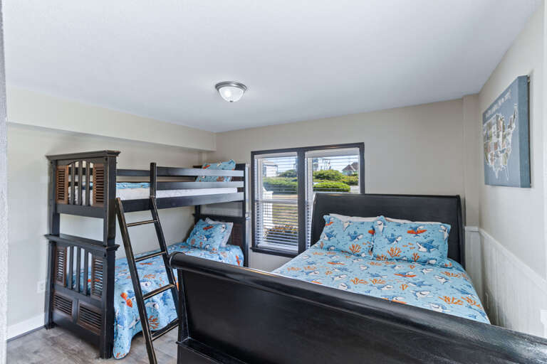This ground floor bunk room has a full-sized bed and twin bunk large closet with a tall chest of drawers and Smart -TV.