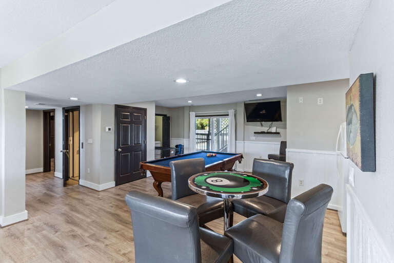 Half bath, kitchenette and laundry all surround this game room just off the pool and hot tub. Everything you'll need is here in this space to have a great time.