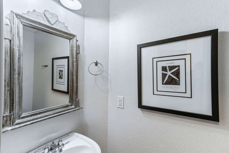 Located in the hall this powder room is clean and functional.