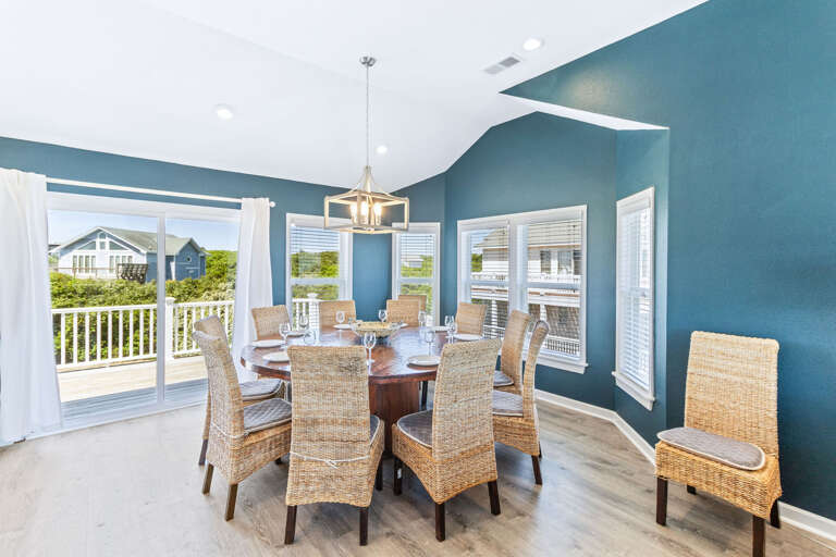 This large round wooden dining table has seating for the entire family to catch up over a meal or games.