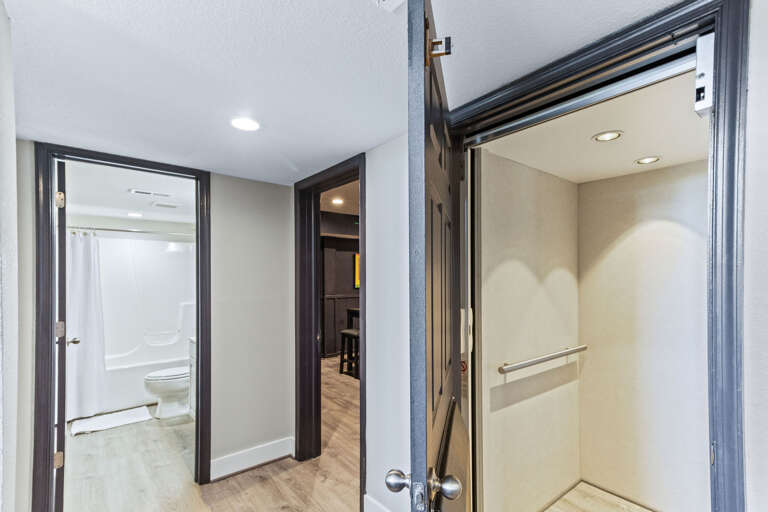 This elevator access is located on the ground level just off the stairs leading to the full bah, theatre and bunkroom.