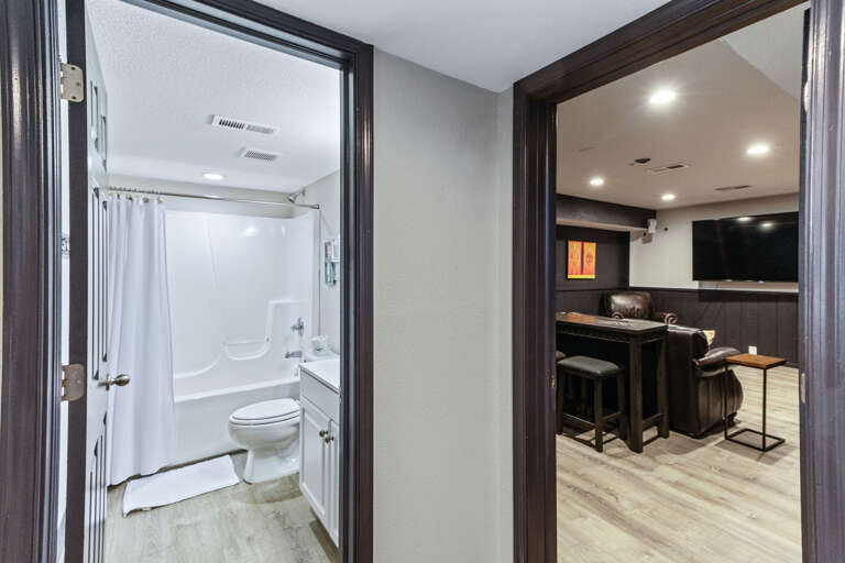 Just off the ground level bunkroom, this hall leads to the theatre and full bath.