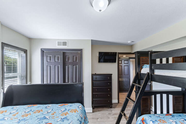 This ground floor bunk room has a full-sized bed and twin bunk large closet with a tall chest of drawers and Smart -TV.