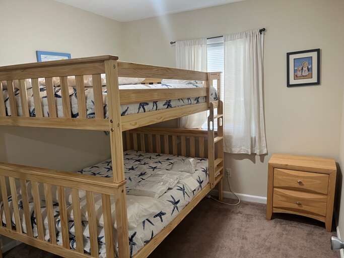 A smart TV and a comfy mattress make for a great twin Full bunk room at Beach bliss.