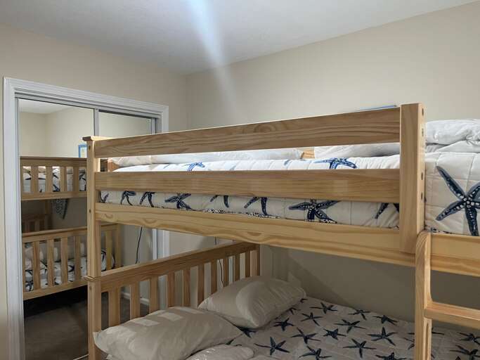 A smart TV and a comfy mattress make for a great twin Full bunk room at Beach bliss.