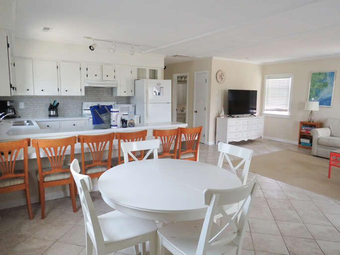 Interior Of A Residential Kitchen And Dining Area With White Furniture And Appliances