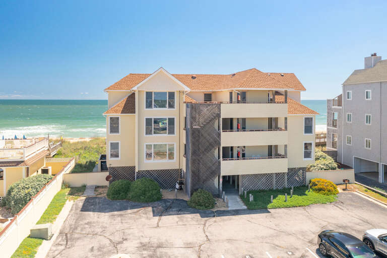 Seaside Multi-story Building With Parking Lot