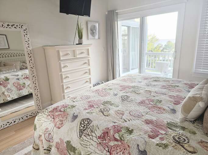 This bright, beautiful and cozy King bedroom is sure to please with an attached bath and balcony access.