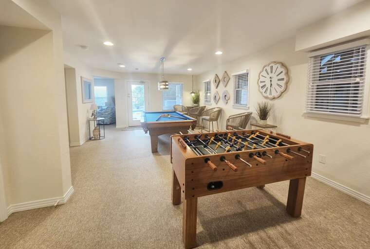 Pool table, foosball table and directors chairs make for a great game room.
