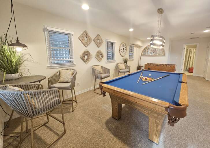Pool table, foosball table and directors chairs make for a great game room.
