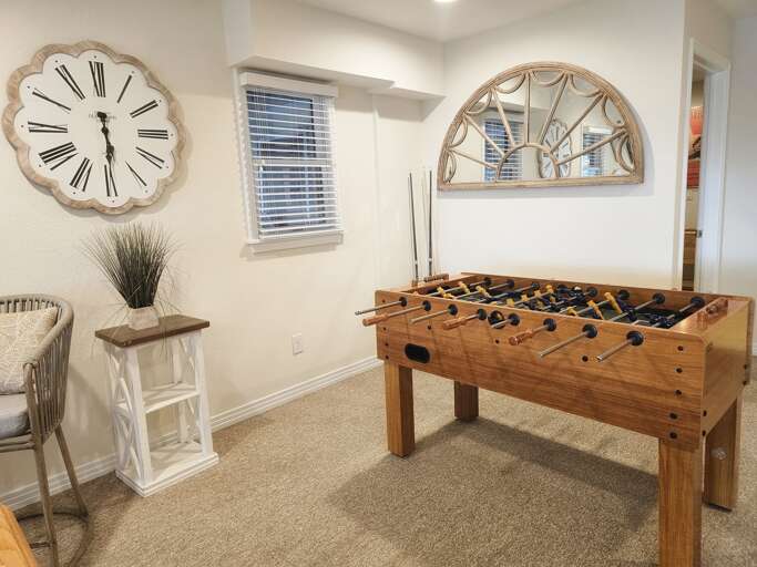 Pool table, foosball table and directors chairs make for a great game room.
