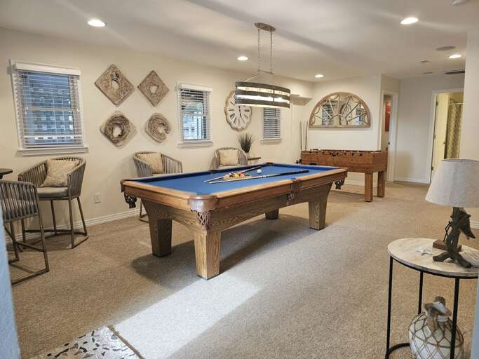 Pool table, foosball table and directors chairs make for a great game room.
