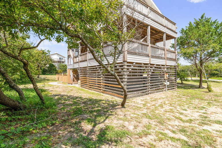 Wooden Building With Balcony Surrounded By Trees