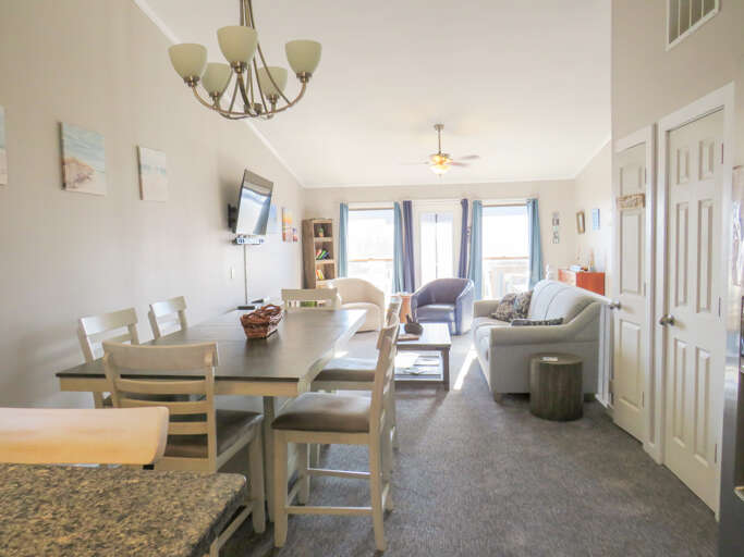 Brightly Lit Living Space With Dining Area, Leading Onto A Balcony